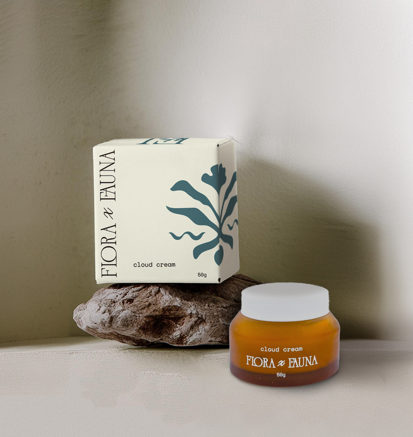 Cloud Cream product box with logo and brandmark on it, sitting on wood next to a jar of the cream.