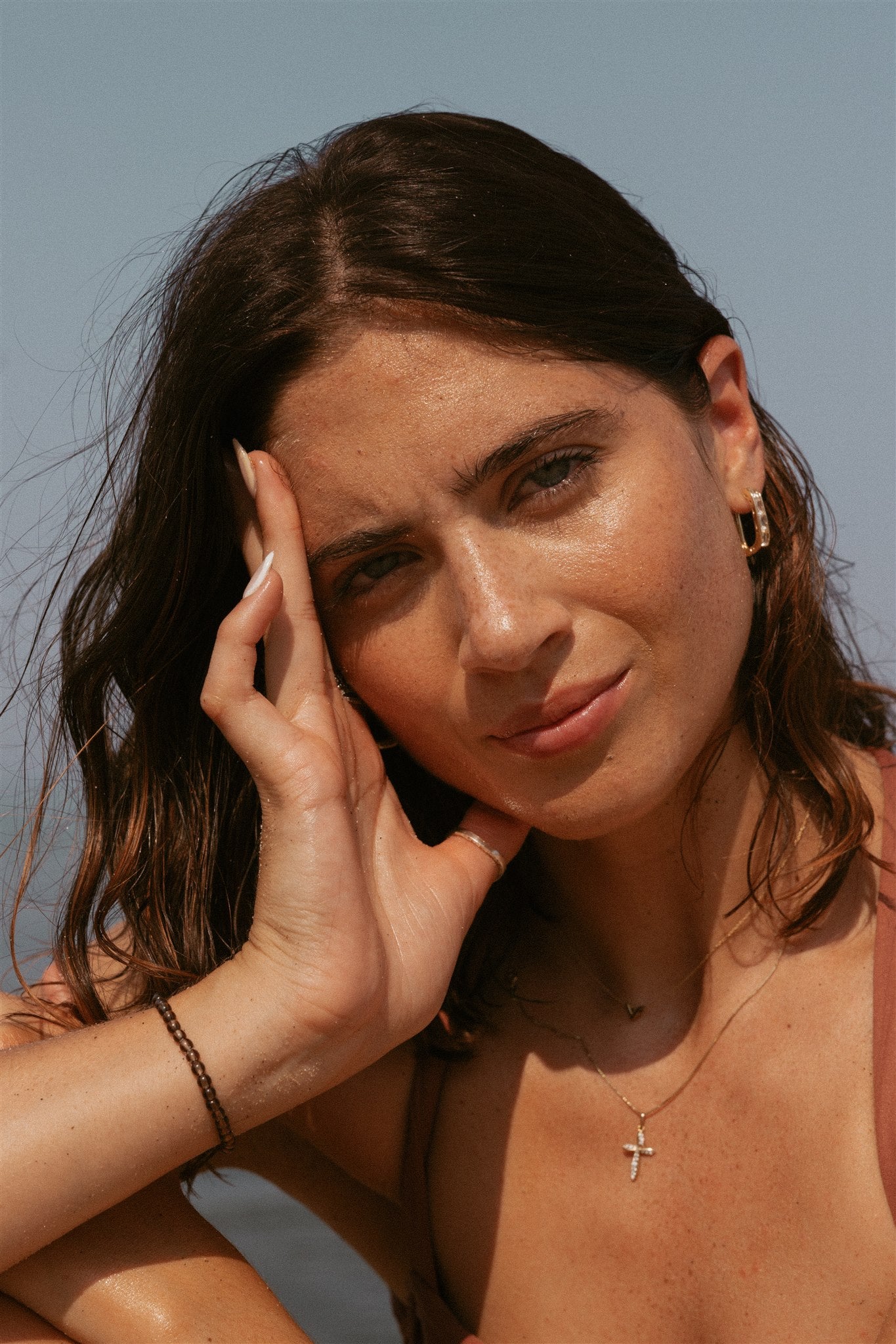 Girl resting head on hand while looking into the camera.